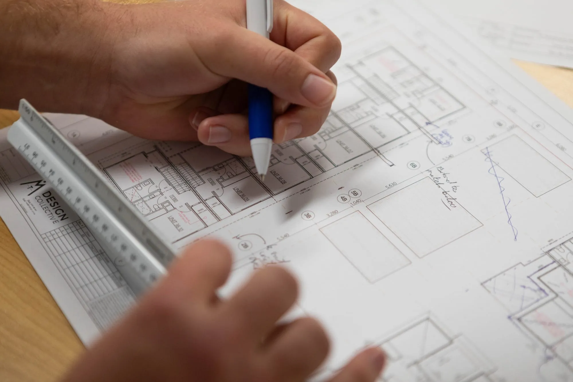 MT Design Collective drafter marking up a printed floor plan set