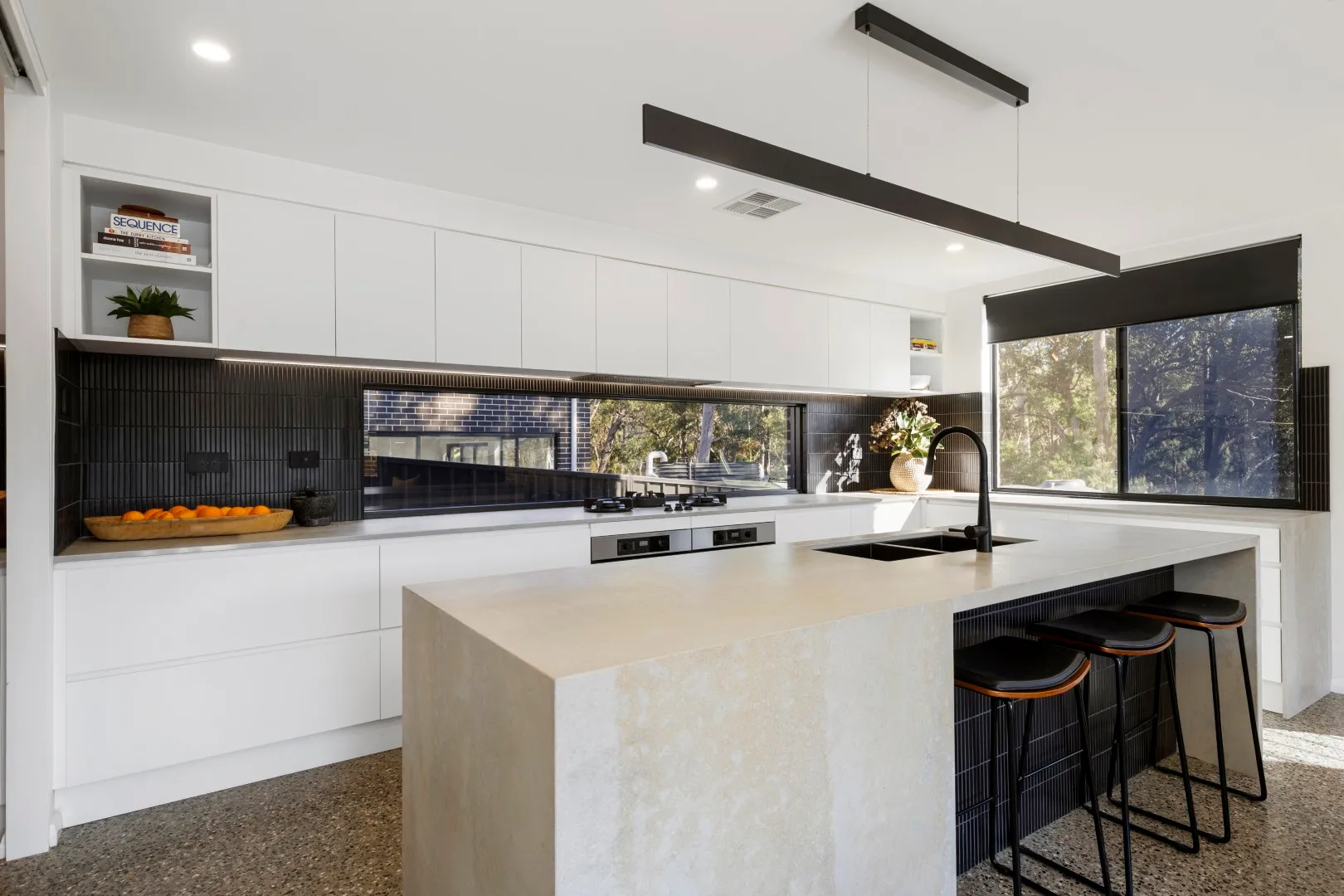 The kitchen and living space of a custom new home by MT Design Collective