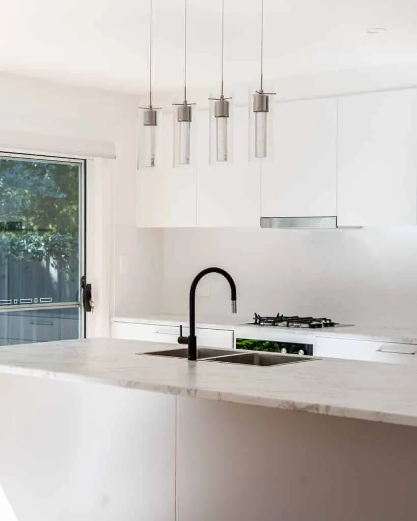 Kitchen with marble island and pendant lighting